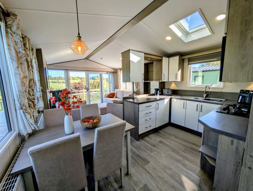 Dining table for four beside the fitted kitchen, looking towards the lounge
